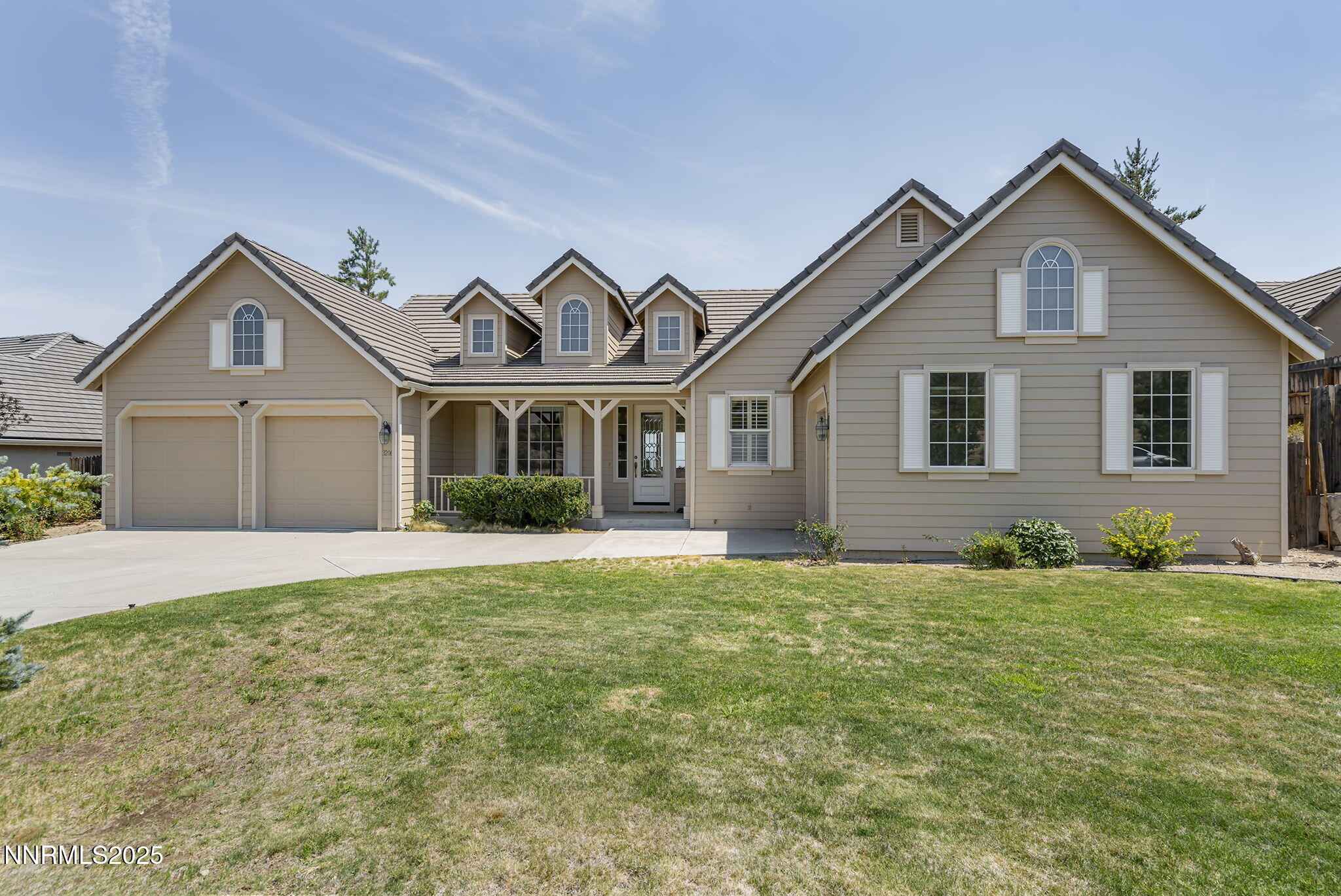 3206 Old Coach Court Reno, NV 89511 - Photo 5 of 40 a front view of a house with a garden and yard