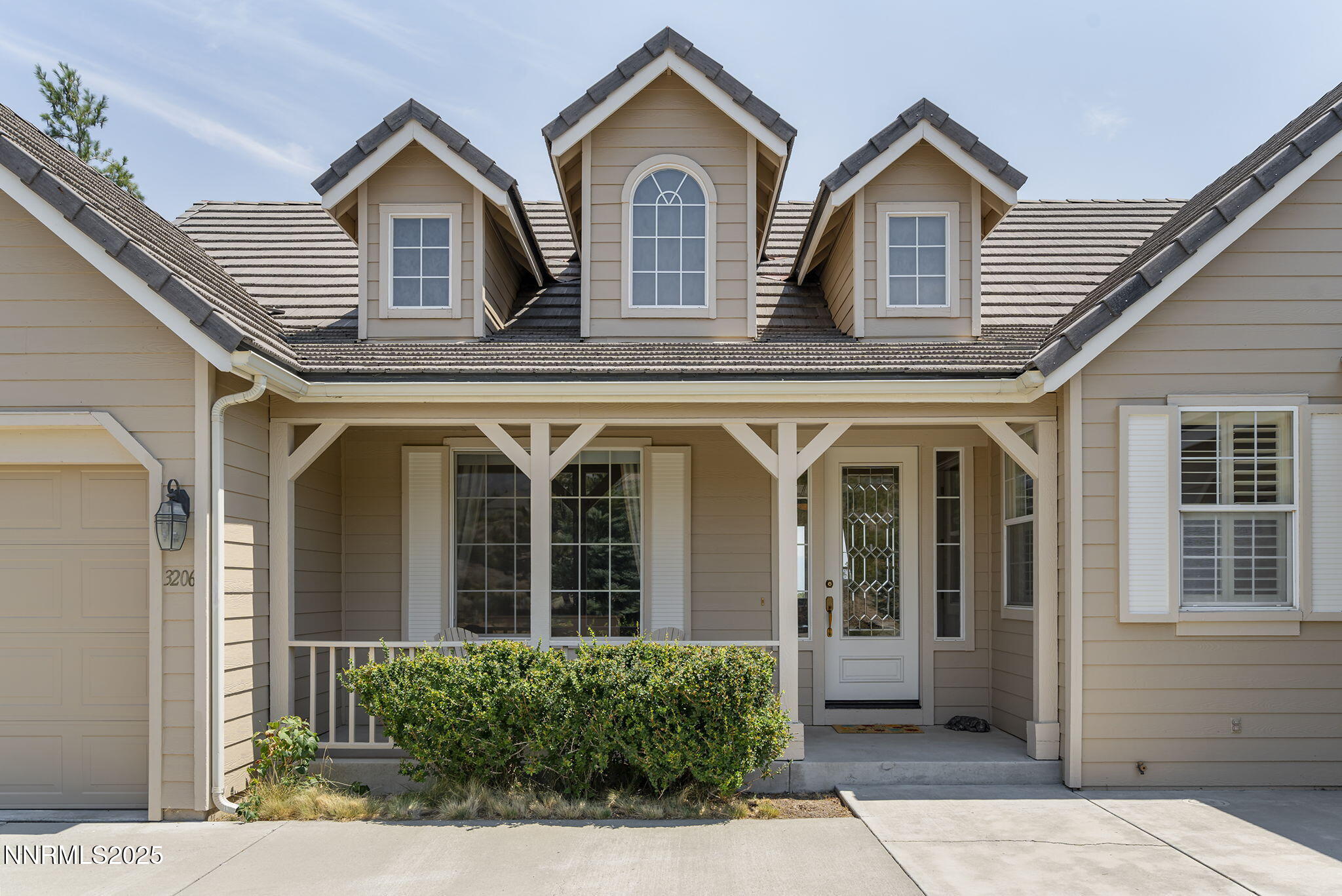3206 Old Coach Court Reno, NV 89511 - Photo 7 of 40 a view of a brick house with large windows
