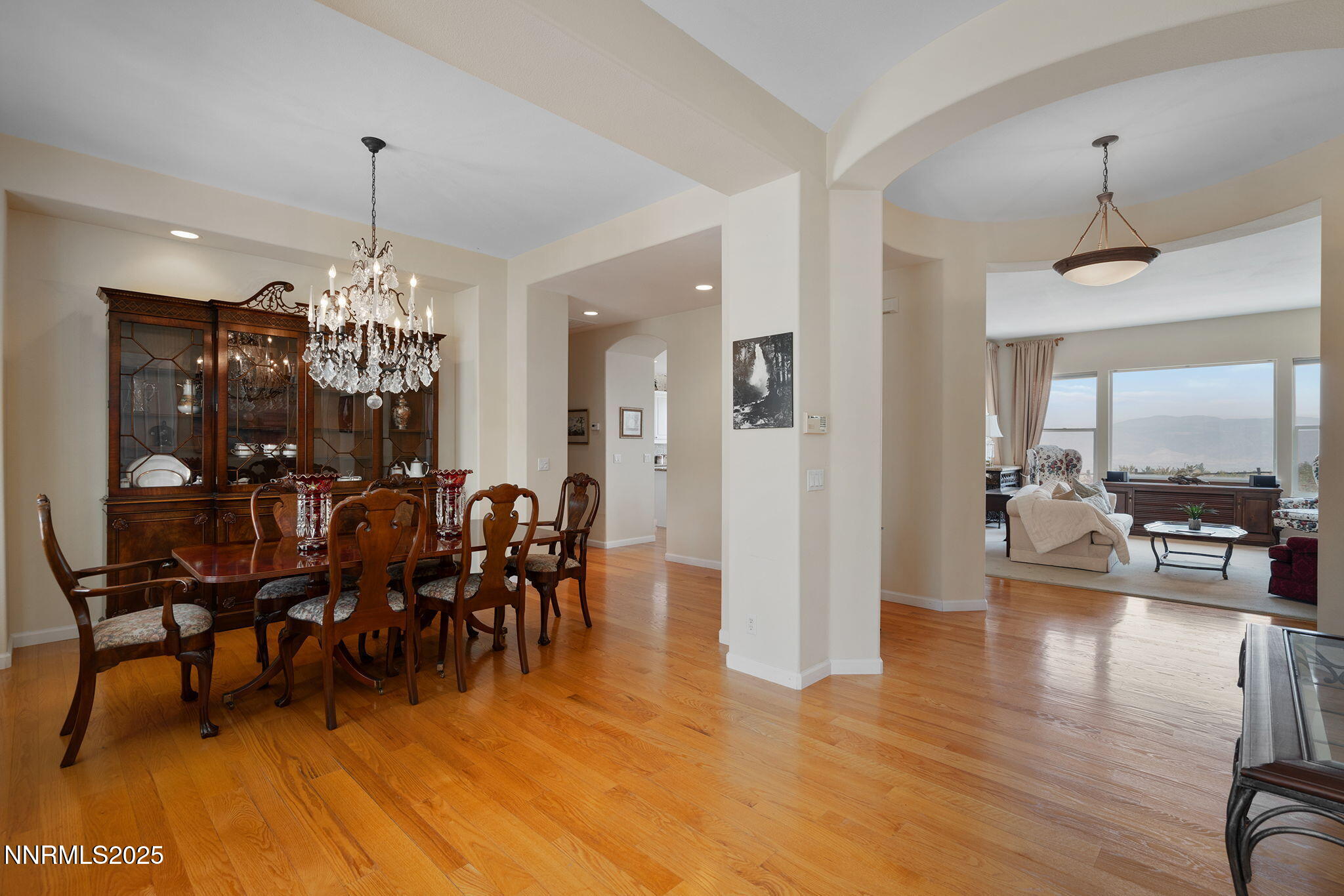 3206 Old Coach Court Reno, NV 89511 - Photo 8 of 40 a view of a dining room and livingroom with furniture wooden floor a chandelier