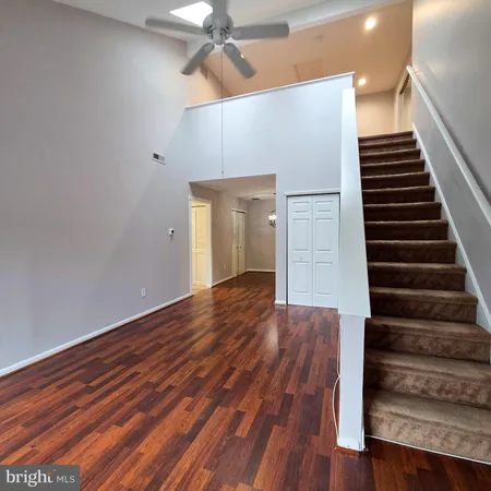 a view of an entryway with wooden floor