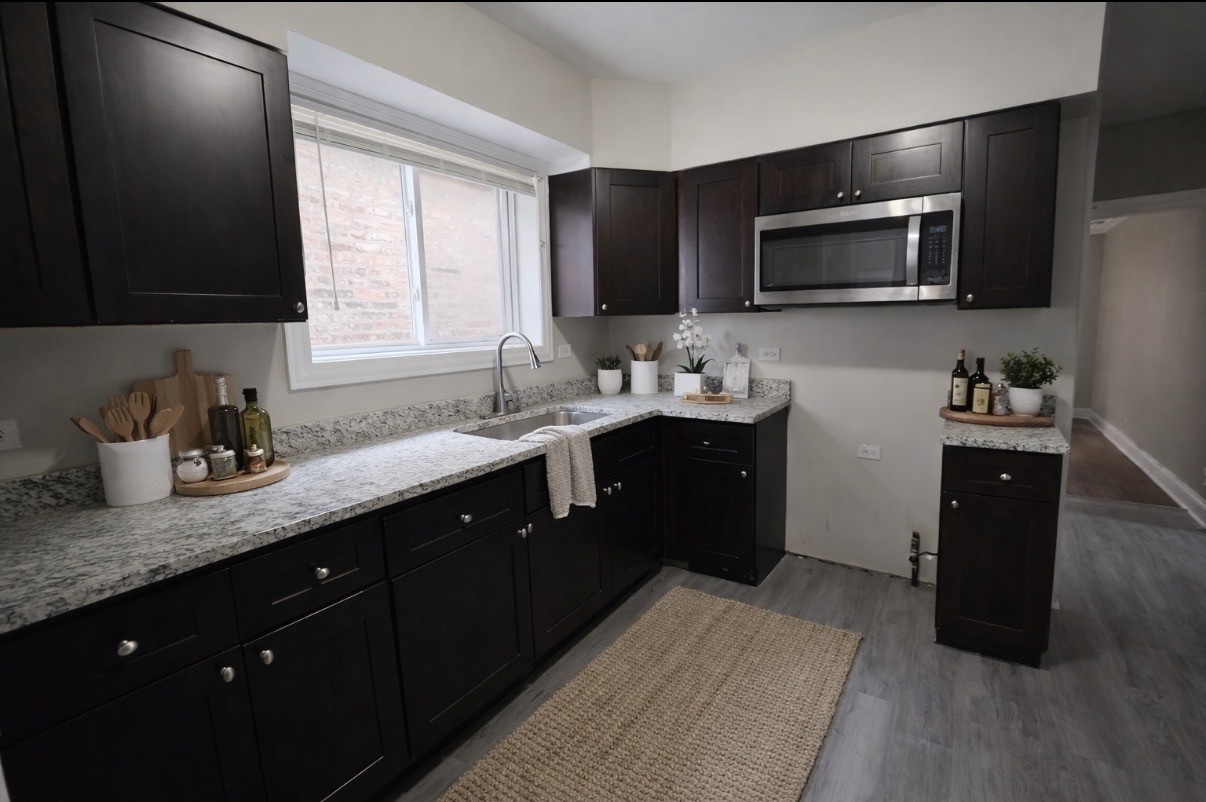 8605 South Laflin Street Chicago, IL 60620 - Photo 2 of 7 a kitchen with a sink stove and microwave
