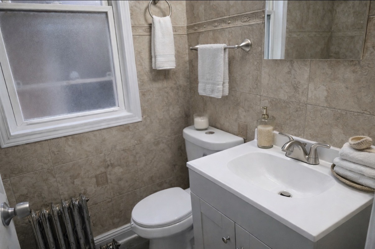 8605 South Laflin Street Chicago, IL 60620 - Photo 7 of 7 a bathroom with a toilet sink and mirror