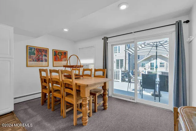 a view of a dining room with furniture wooden floor and flat screen tv
