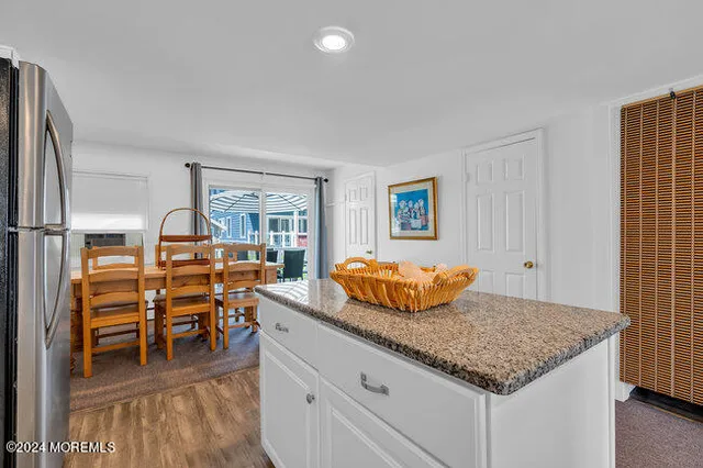 a kitchen with stainless steel appliances granite countertop a sink and a refrigerator