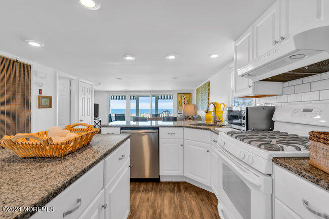 0 Beach Front Manasquan, NJ 08736 - Photo 21 of 47 a kitchen with stainless steel appliances granite countertop a sink and cabinets