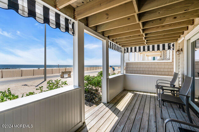 0 Beach Front Manasquan, NJ 08736 - Photo 3 of 47 a view of balcony with wooden floor and outdoor seating