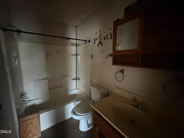 a bathroom with a shower a toilet and sink