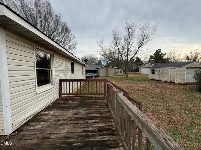 a view of a wooden deck and a yard