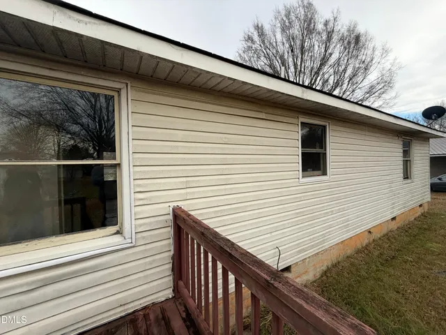 a view of a wooden house with a large window