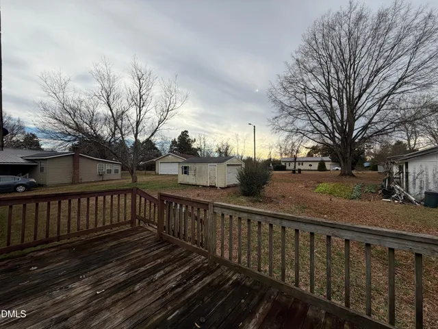 a view of a street with wooden fence