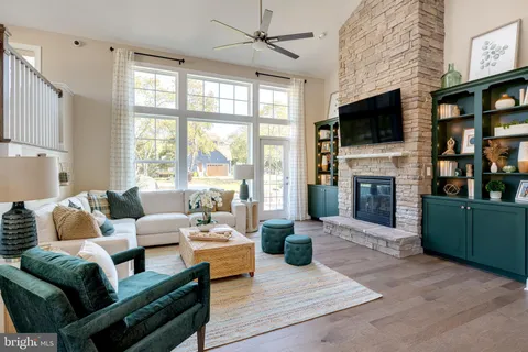 a living room with fireplace furniture and a flat screen tv