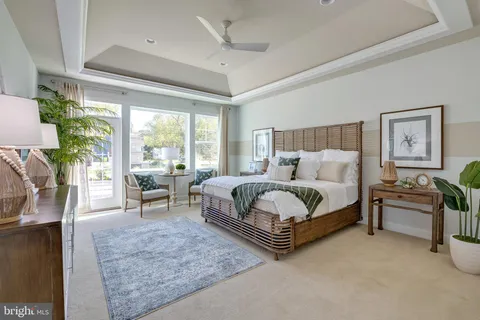 a bedroom with a bed and large windows