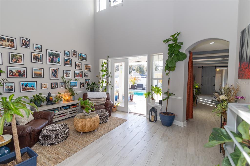 3305 Schoolhouse Road St. Cloud, FL 34773 - Photo 17 of 83 a living room with furniture and flower plants