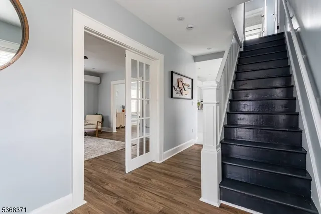 a view of a hallway with wooden floor and entryway