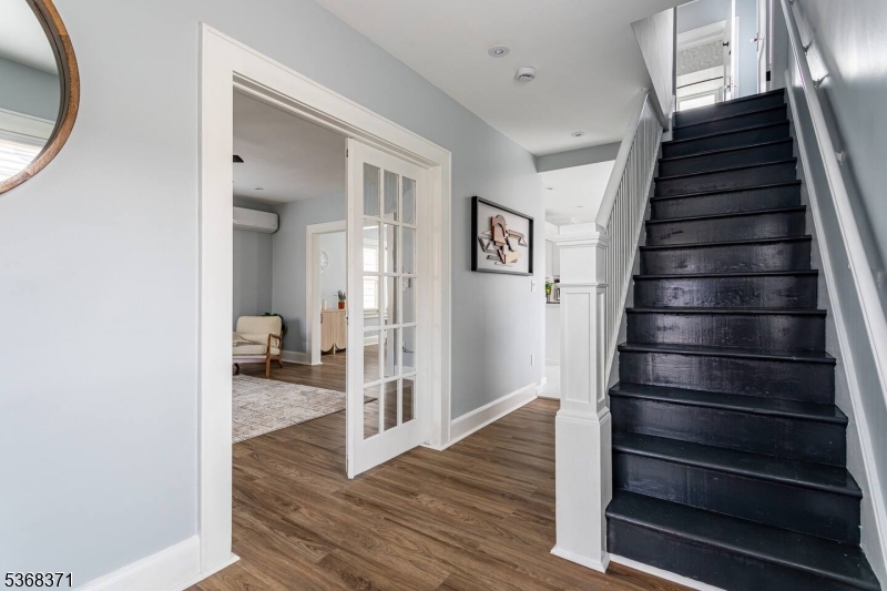 a view of a hallway with wooden floor and entryway