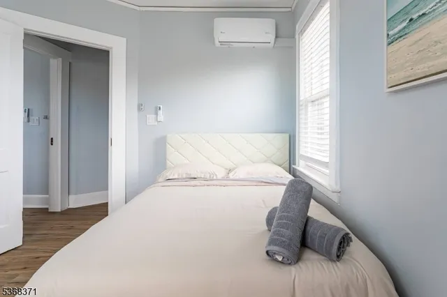 a bedroom with a bed and a window