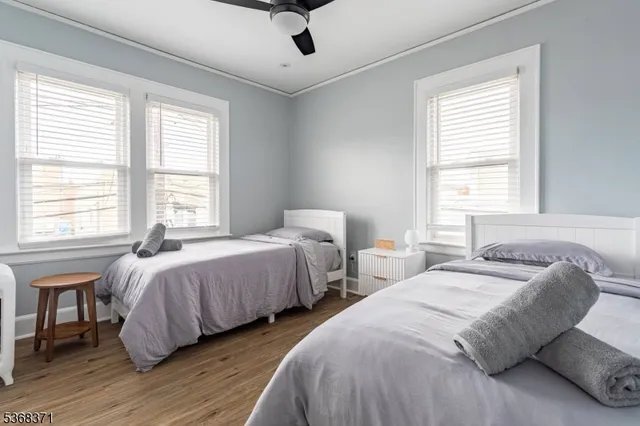 a bedroom with two beds and a window