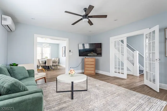 a living room with furniture a rug and a flat screen tv