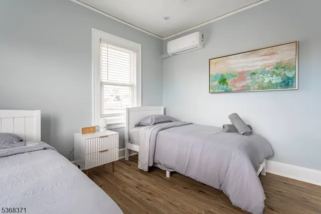 a bedroom with bed and a painting on the wall