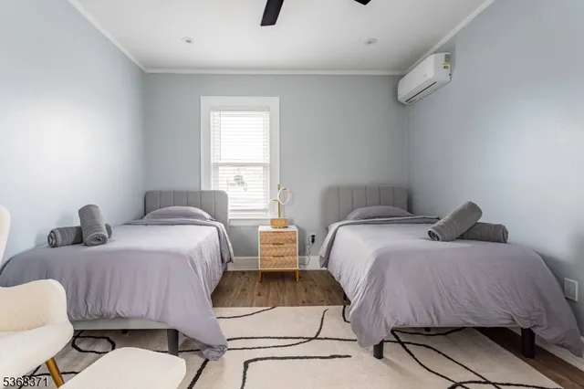 a bedroom with two beds and a chair