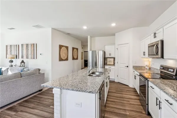 a kitchen with stainless steel appliances granite countertop a stove and a sink