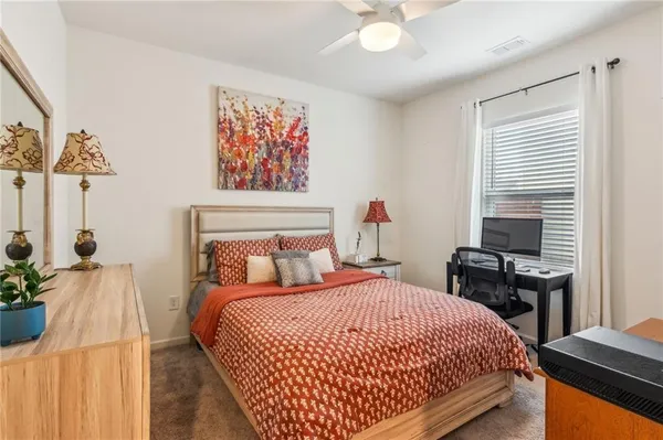 a bedroom with a bed and a painting on the wall
