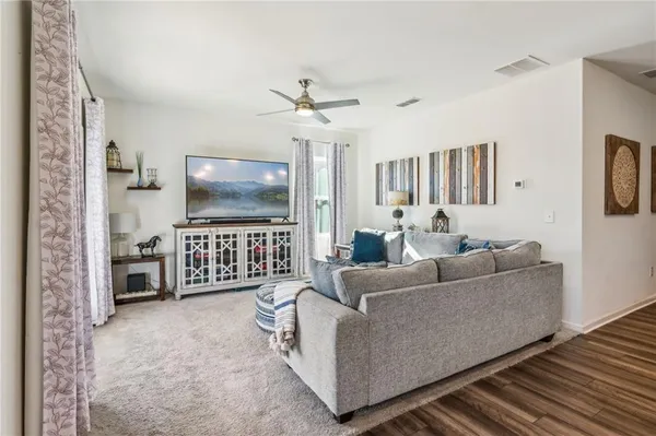a living room with furniture and kitchen view