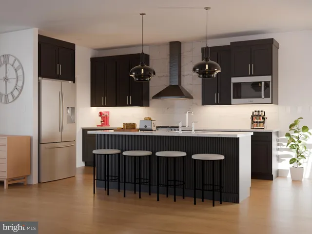 a kitchen with stainless steel appliances granite countertop a refrigerator and a stove top oven