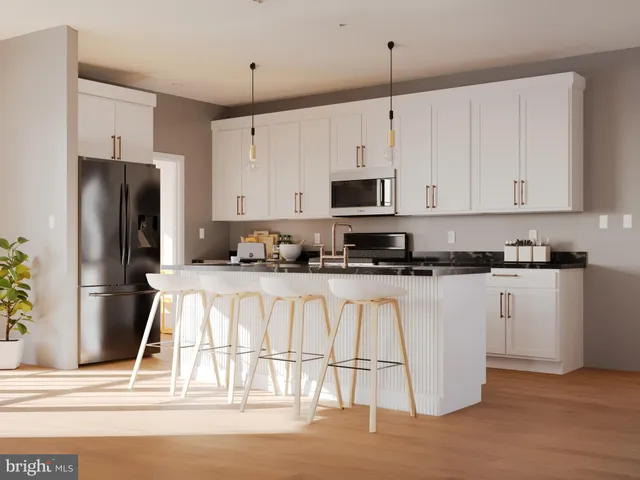 a kitchen with stainless steel appliances granite countertop a refrigerator a stove a sink and white cabinets