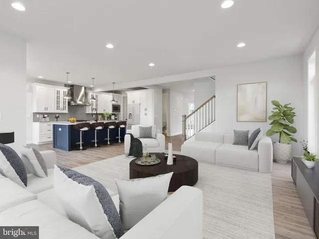 a living room with furniture and kitchen view