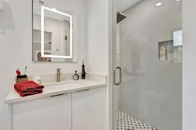 a bathroom with a sink vanity and a mirror