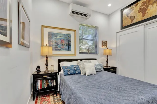 a bed room with a bed and painting on the wall