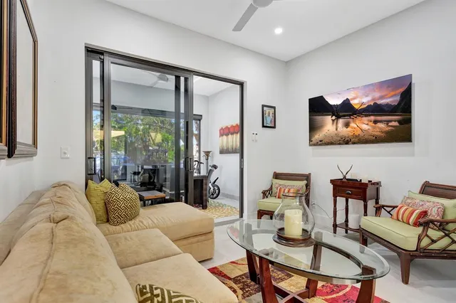 a living room with furniture and a floor to ceiling window