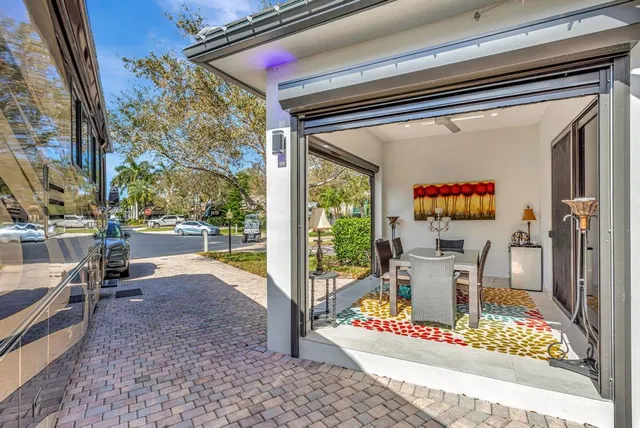 a living room with furniture and a floor to ceiling window