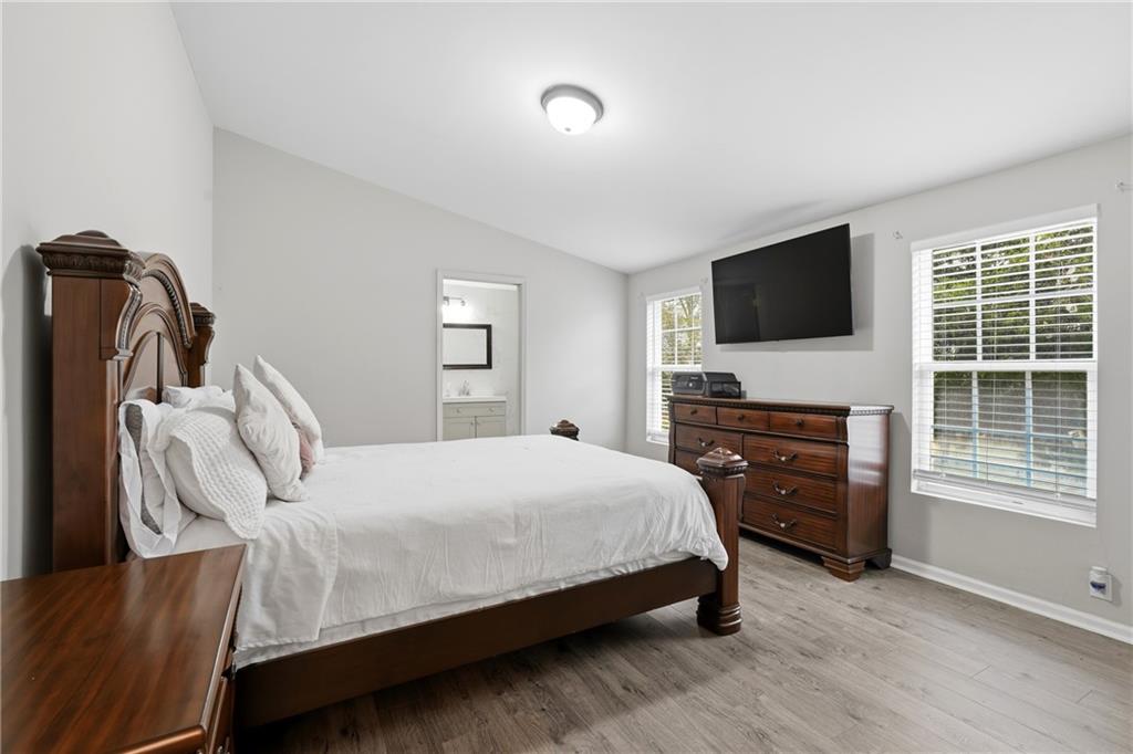 1295 Double Bridges Road Winder, GA 30680 - Photo 14 of 57 a bedroom with a bed and a flat screen tv