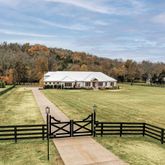 a view of swimming pool with a bench and trees in the background