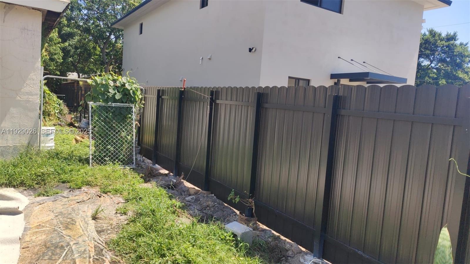 1901 Northwest 51st Terrace Miami, FL 33142 - Photo 12 of 13 a view of a house with wooden fence