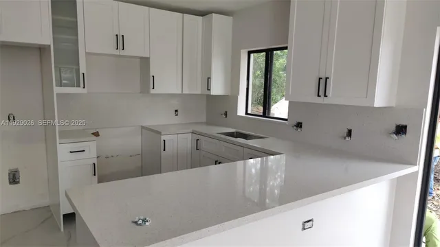 a view of a kitchen sink and cabinets