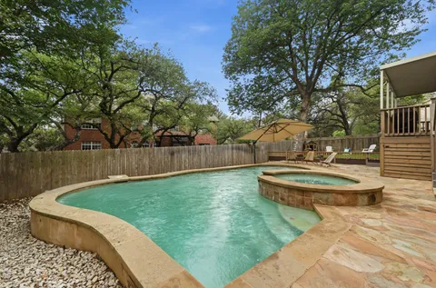 a view of a backyard with plants and lake view