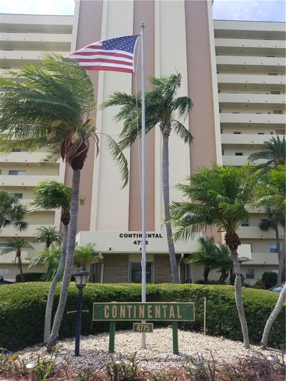 a front view of multi story residential apartment building with yard
