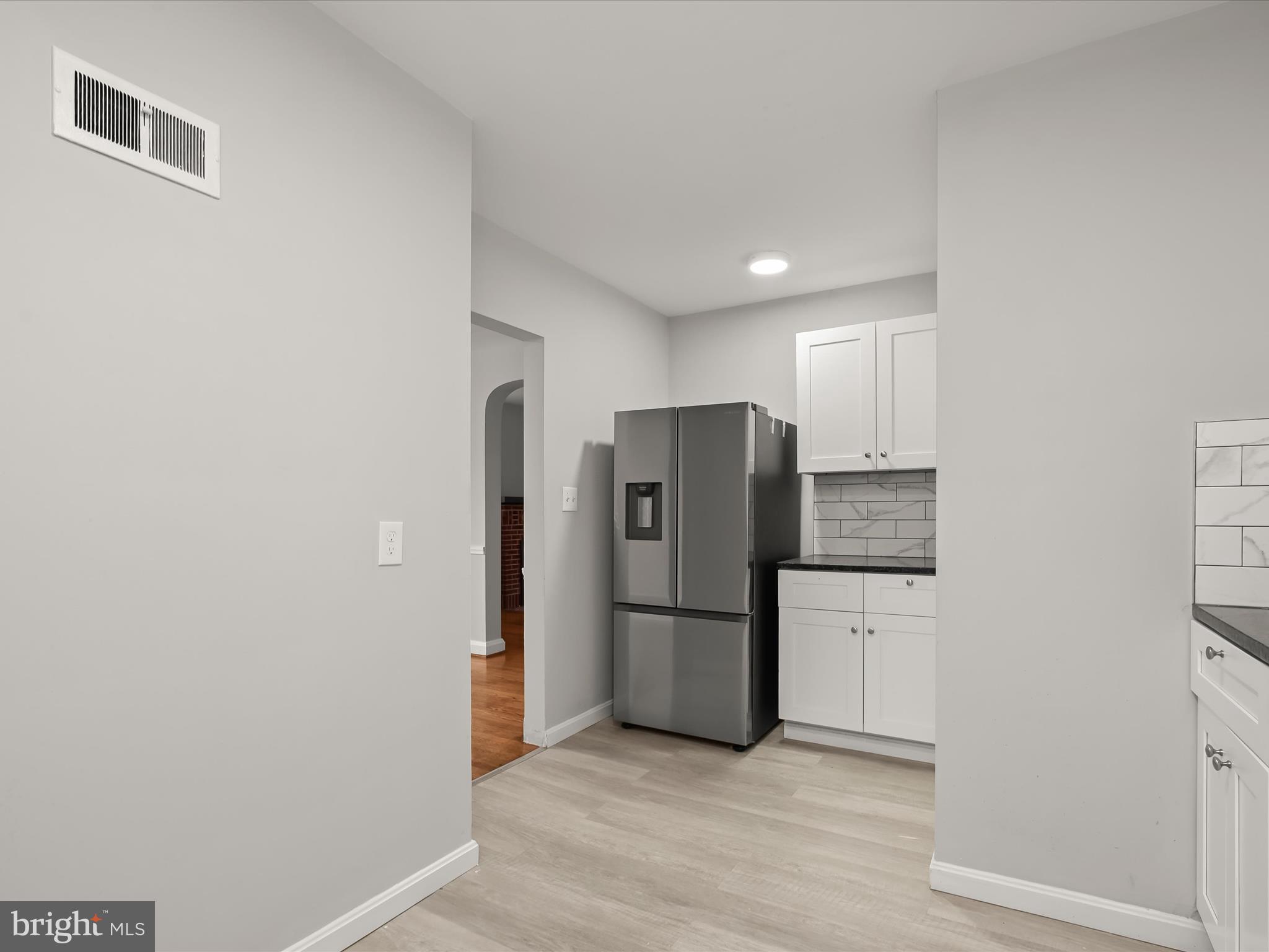 714 Stamford Road Baltimore, MD 21229 - Photo 12 of 31 a view of a kitchen with a refrigerator a microwave and a sink