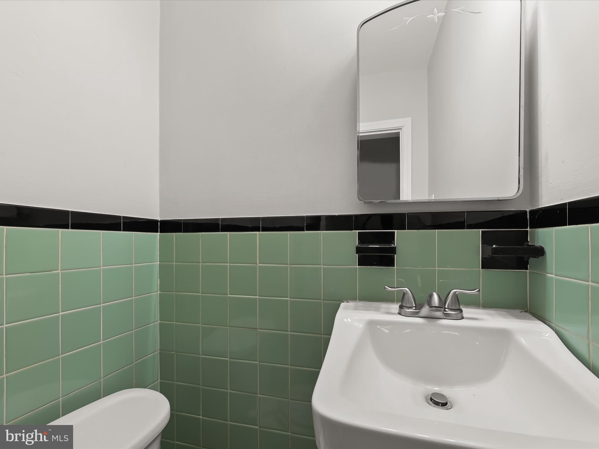 714 Stamford Road Baltimore, MD 21229 - Photo 14 of 31 a bathroom with a sink a toilet and mirror
