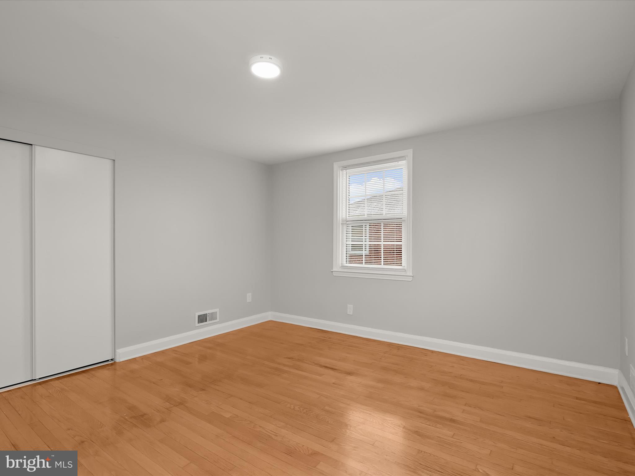 714 Stamford Road Baltimore, MD 21229 - Photo 16 of 31 wooden floor in an empty room with a window