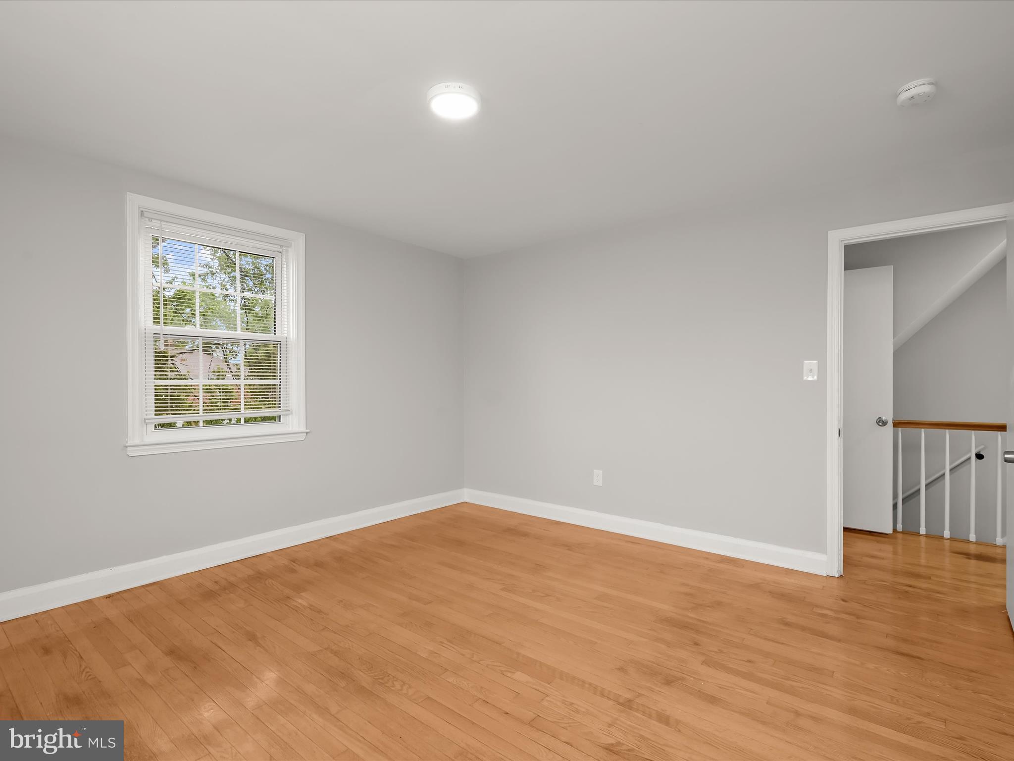 714 Stamford Road Baltimore, MD 21229 - Photo 18 of 31 wooden floor in an empty room with a window