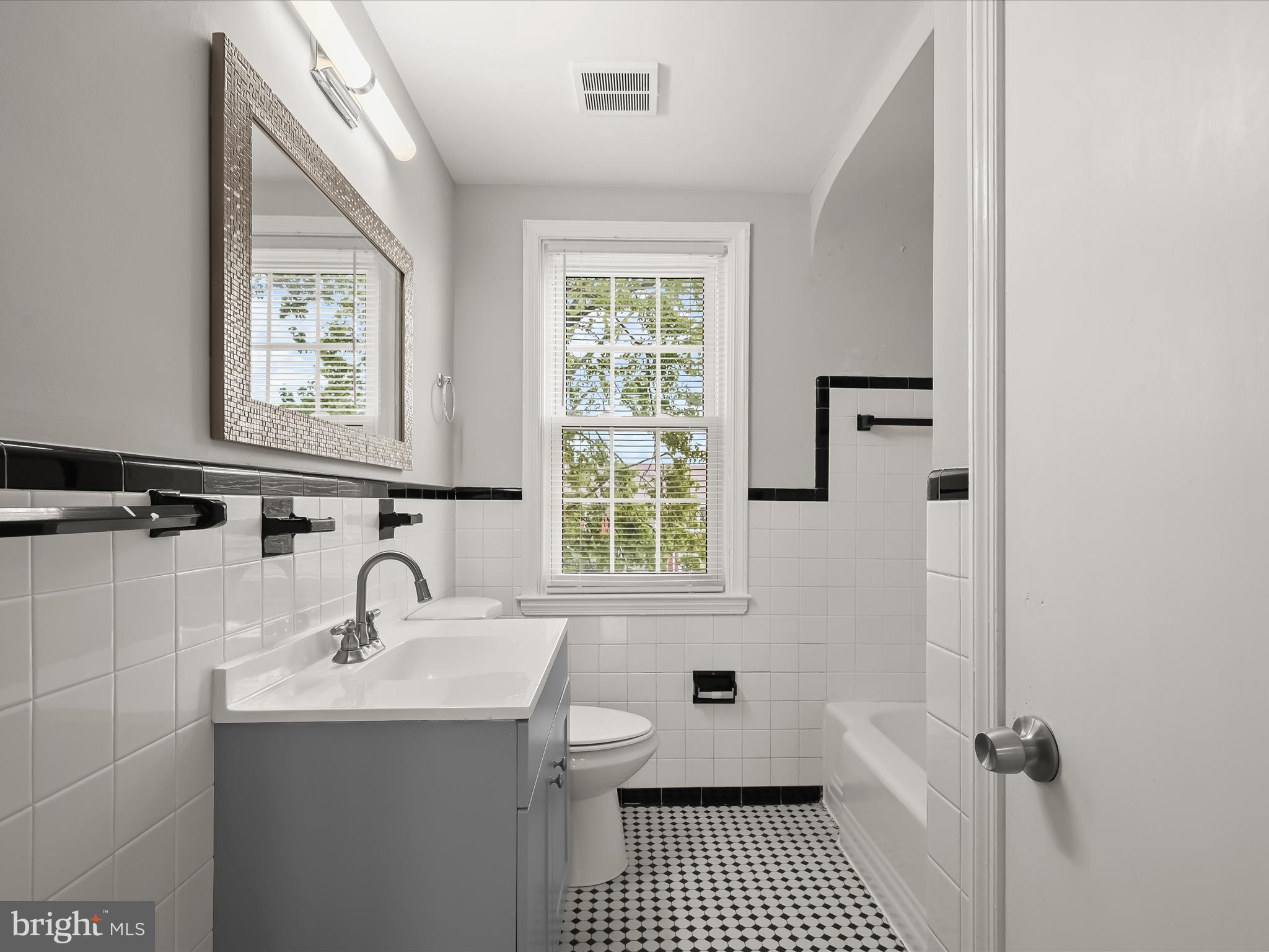 714 Stamford Road Baltimore, MD 21229 - Photo 19 of 31 a bathroom with a sink a toilet and a window