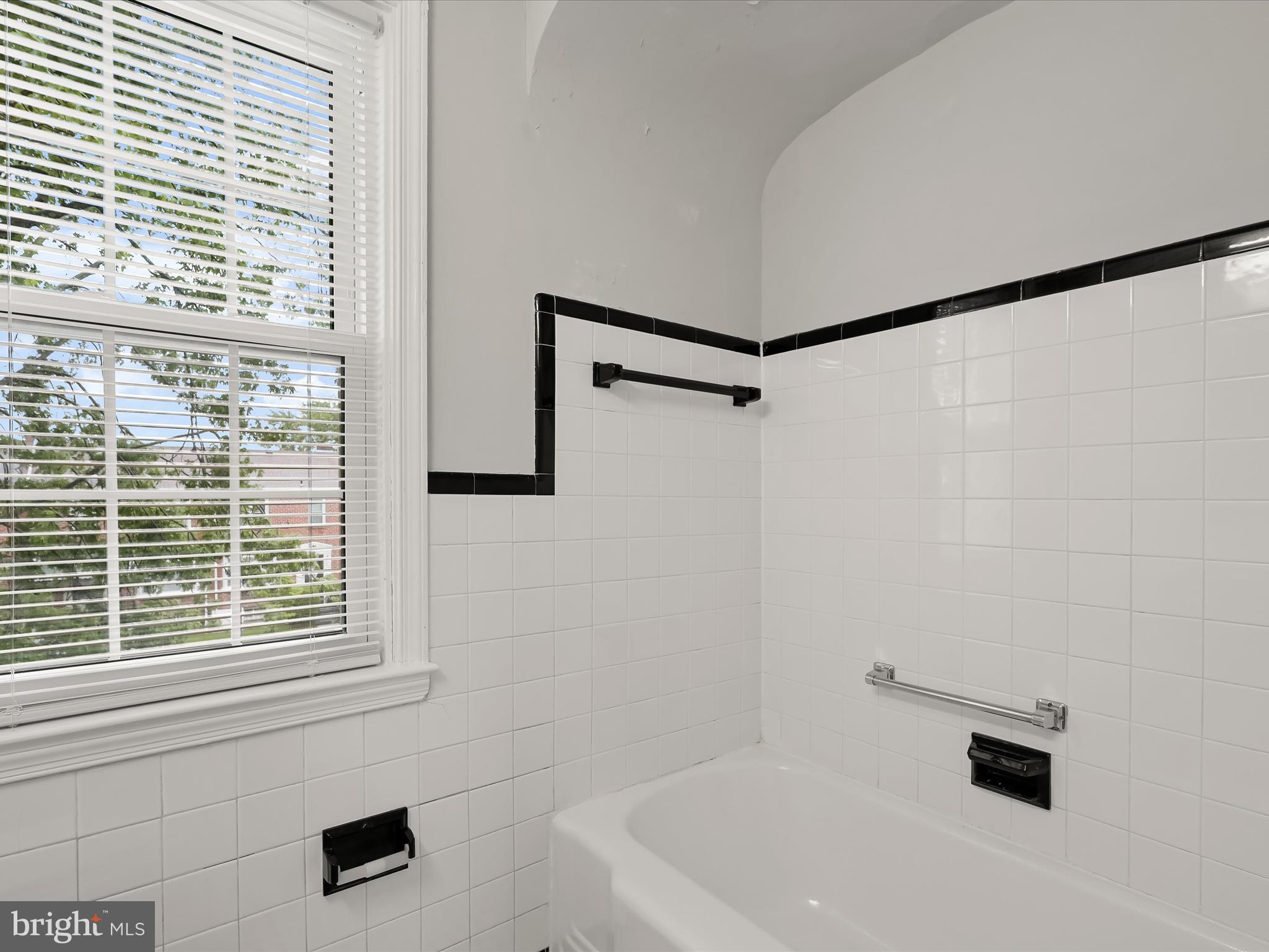 714 Stamford Road Baltimore, MD 21229 - Photo 21 of 31 a bathroom with a bathtub and a shower