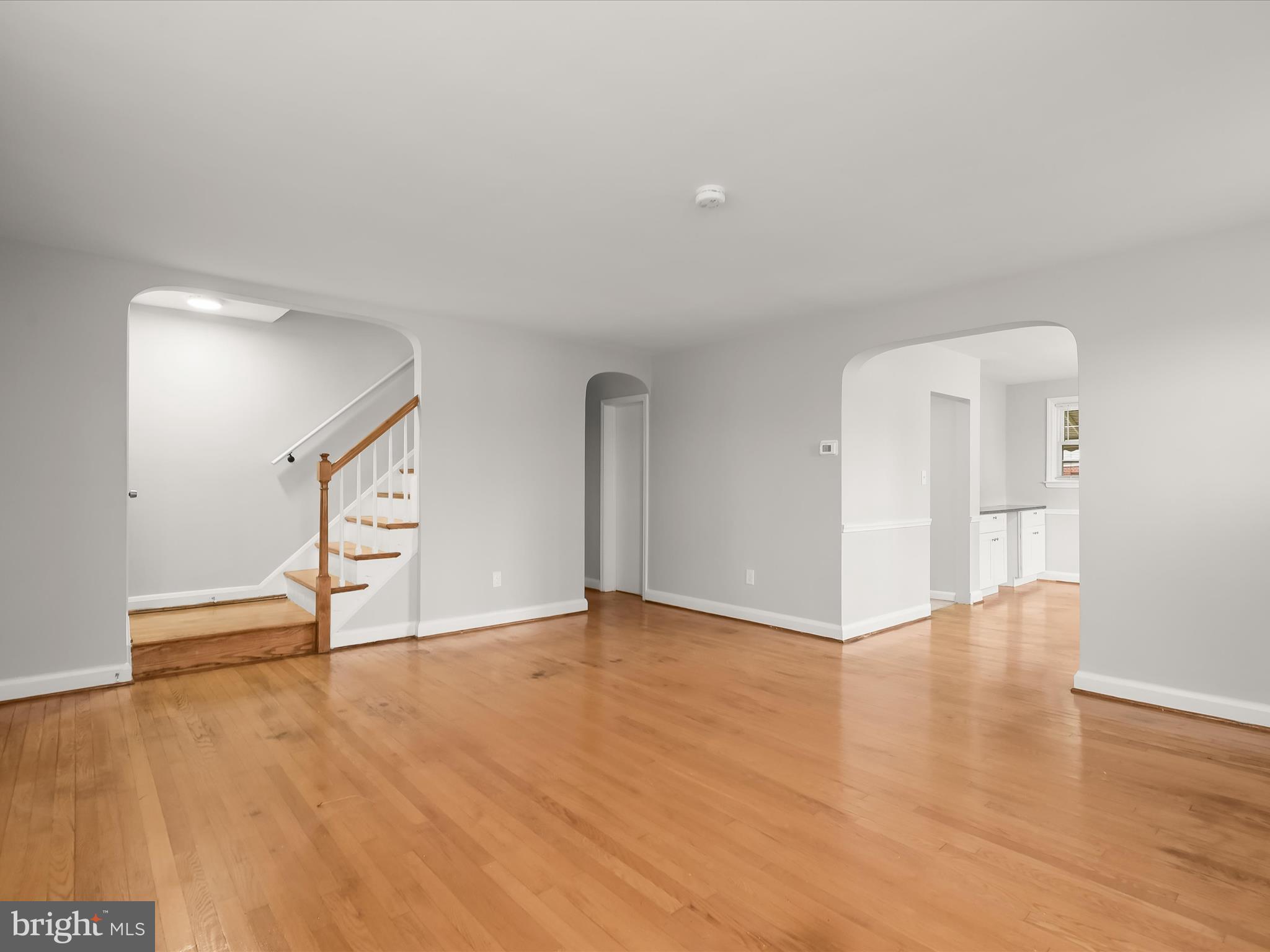 714 Stamford Road Baltimore, MD 21229 - Photo 4 of 31 a view of an empty room with wooden floor