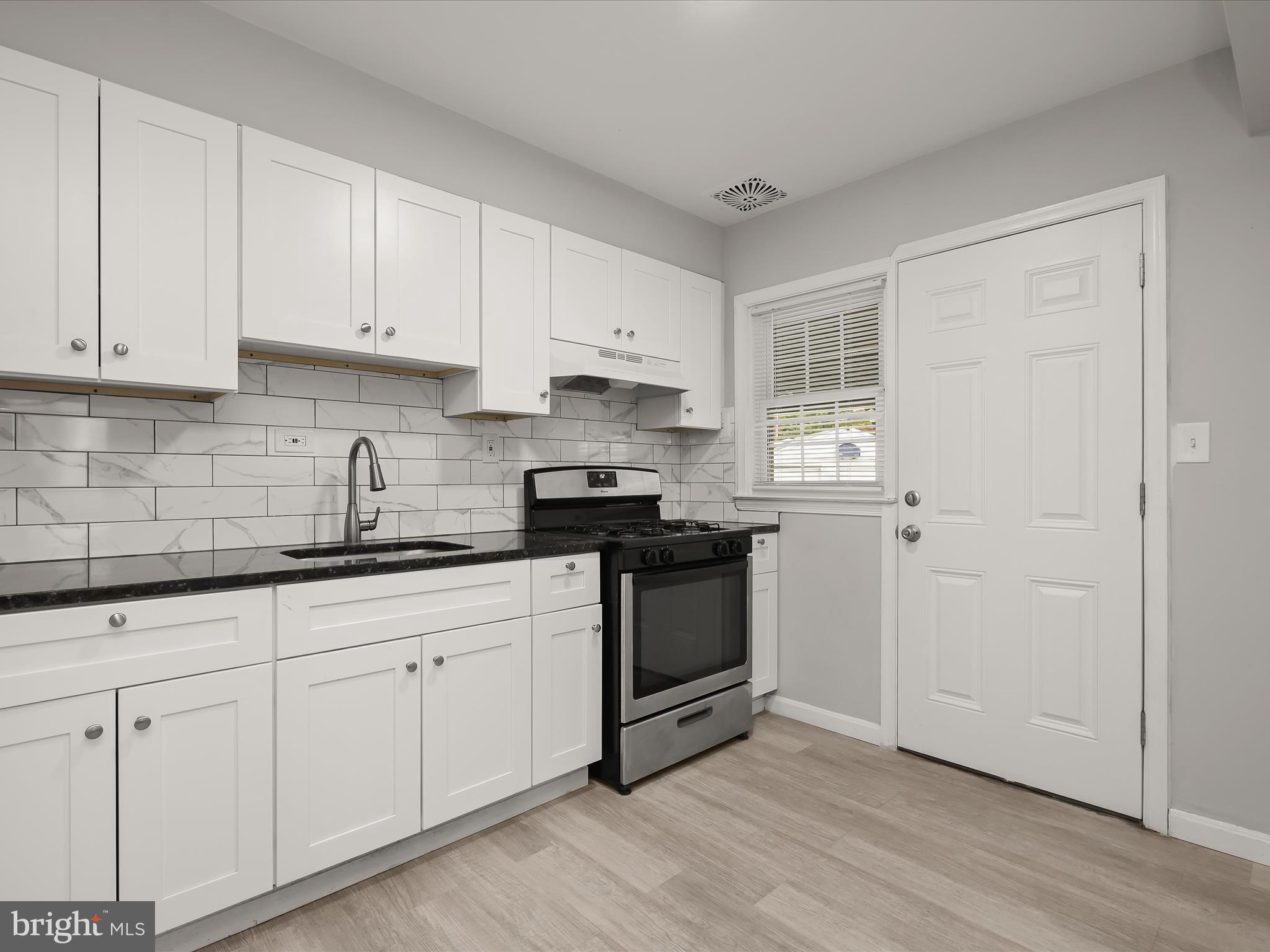 714 Stamford Road Baltimore, MD 21229 - Photo 10 of 31 a kitchen with granite countertop white cabinets and appliances
