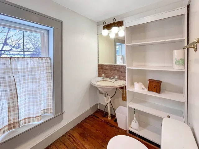 a bathroom with a sink vanity and a mirror