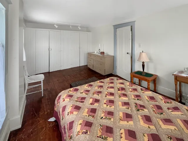 a bedroom with a bed and a mirror